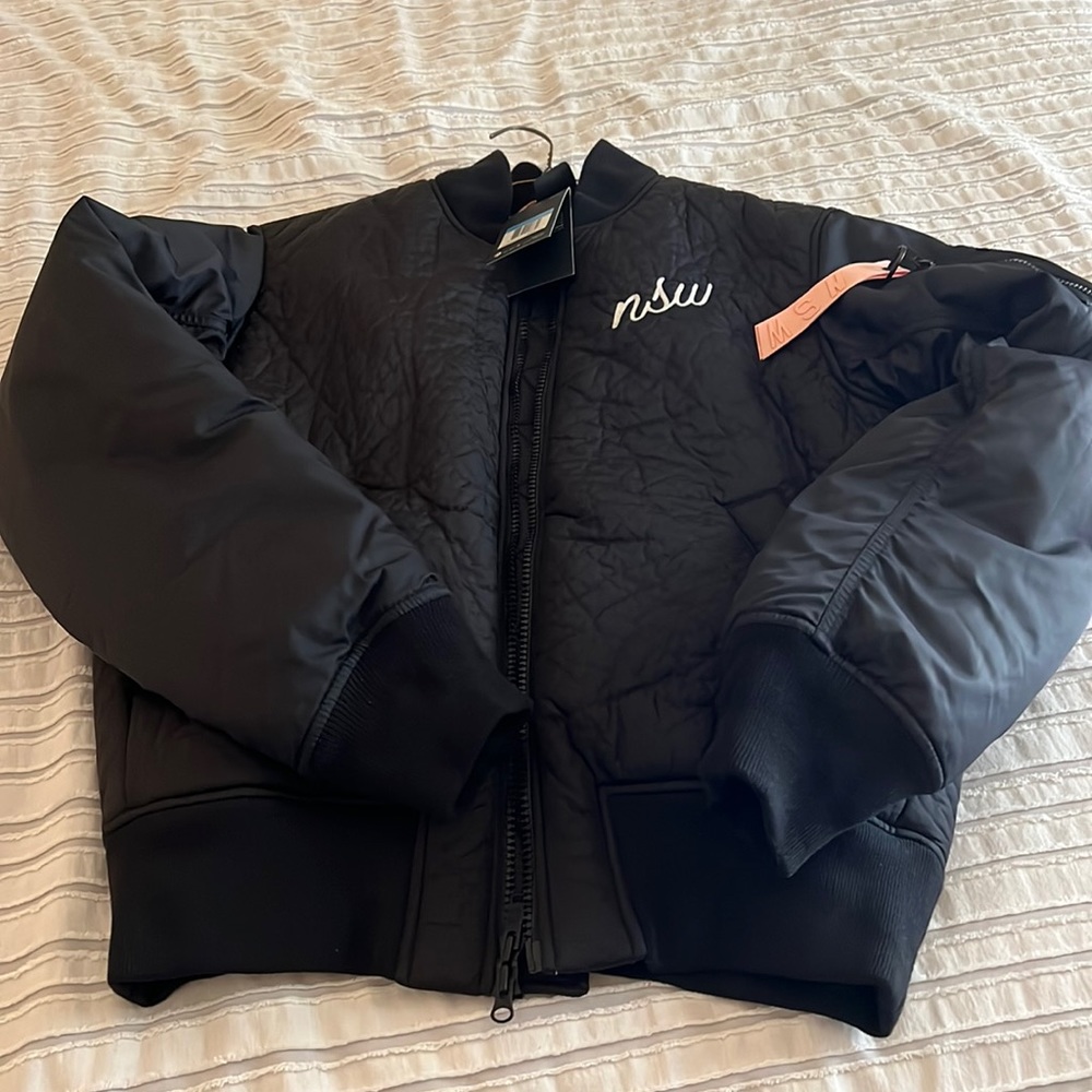 Nike Sports Wear jacket size medium. Black with pink lining. NWT